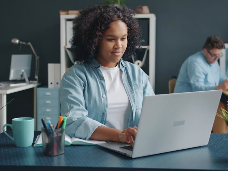 A professional working on her laptop at an organised desk